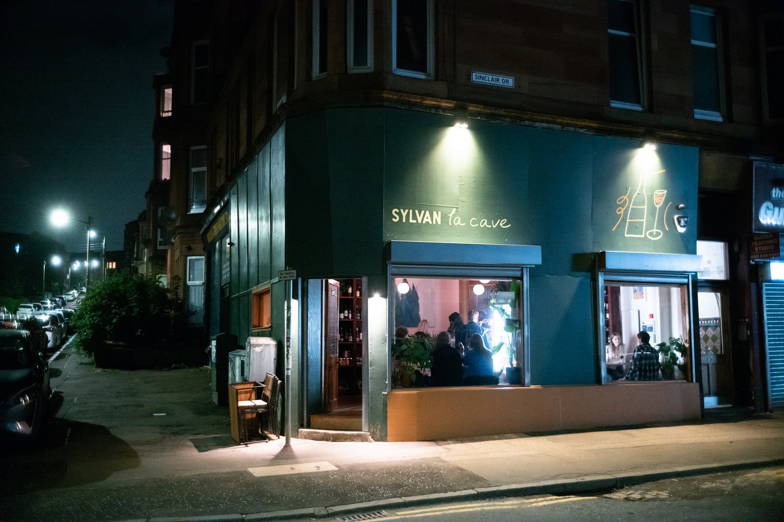 The illuminated Sylvan La Cave frontage on Sinclair Drive