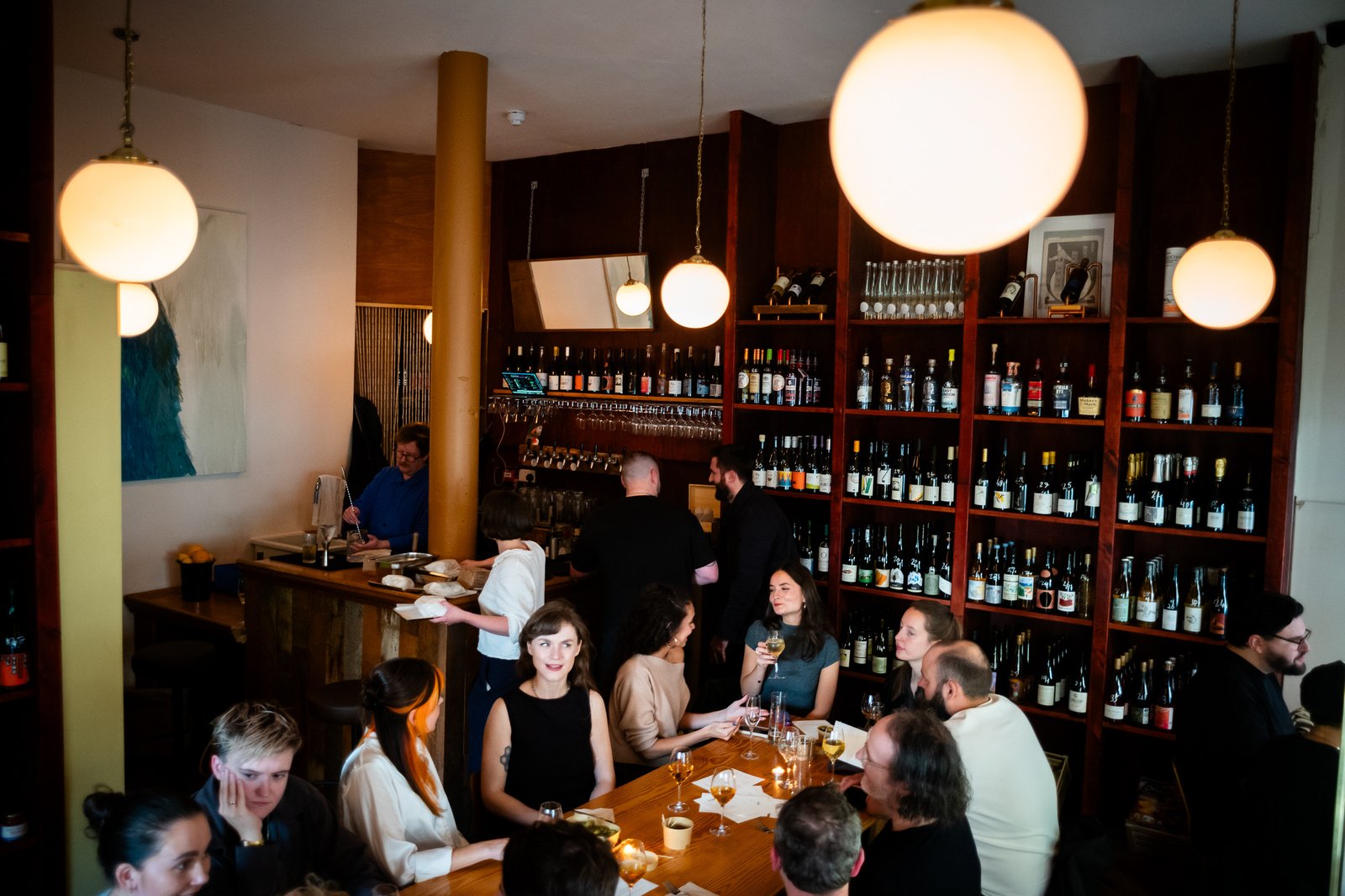 Guests gathered around the bar at La Cave
